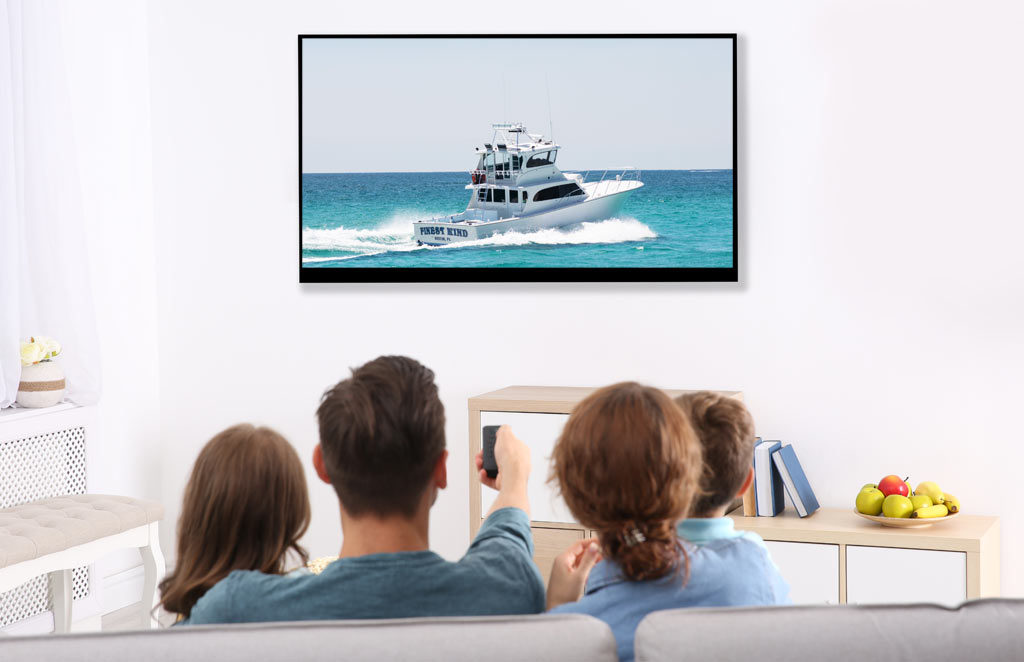 Family watching TV planning deep sea fishing vacation